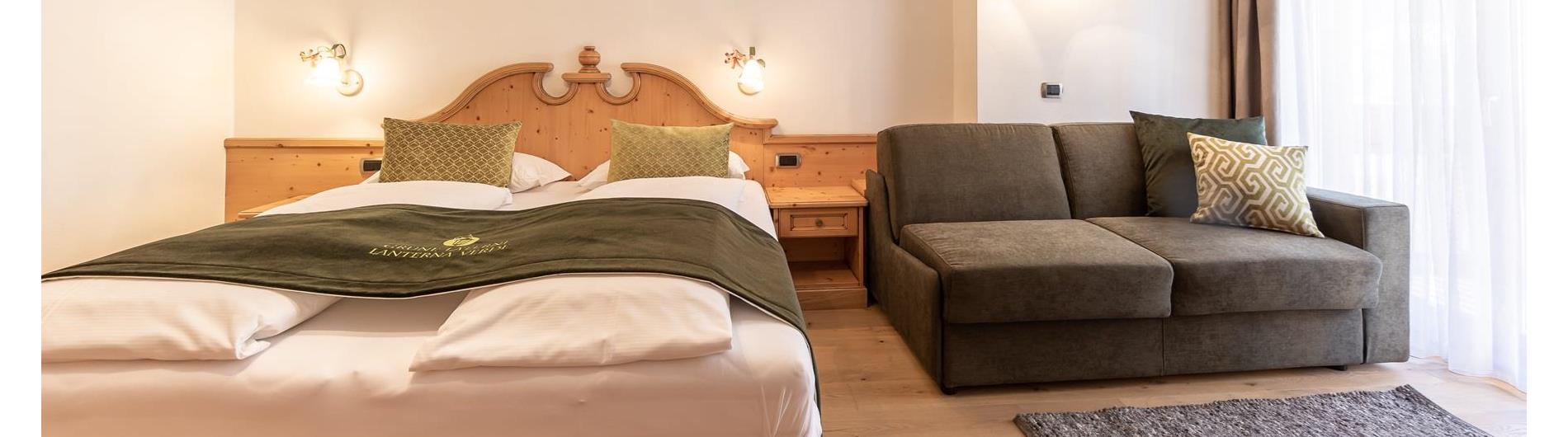 Bed and sofa in the Comfort room