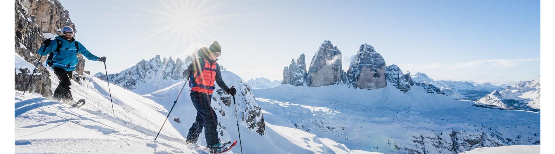 Snowshoer with a panoramic view of the Three Peaks (Drei Zinnen)