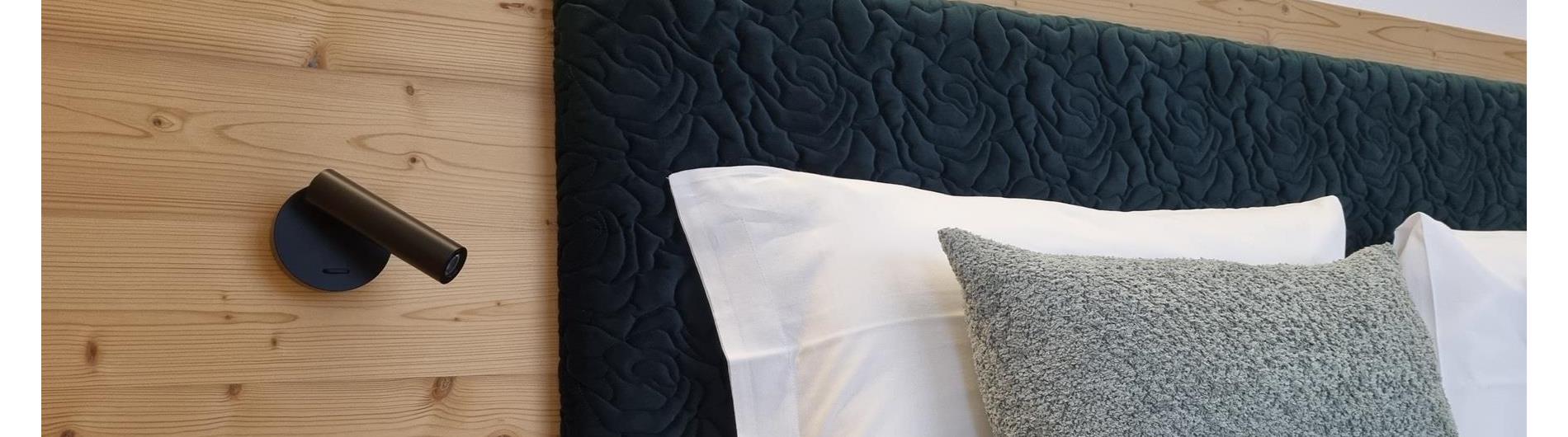 Bed headboard made of green patterned fabric