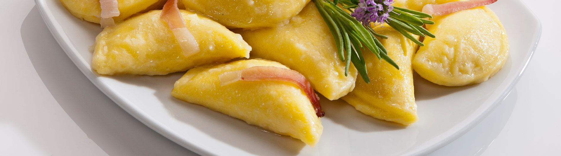 Dumplings served with strips of speck