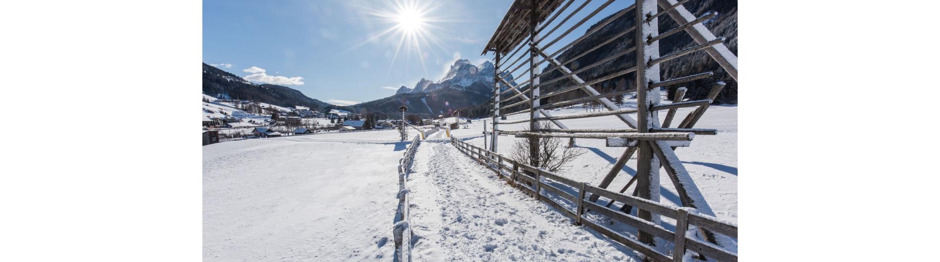 Winter hiking trail with sunlight and mountain view in the village