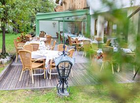 Winter garden and set tables in the outdoor area in summer